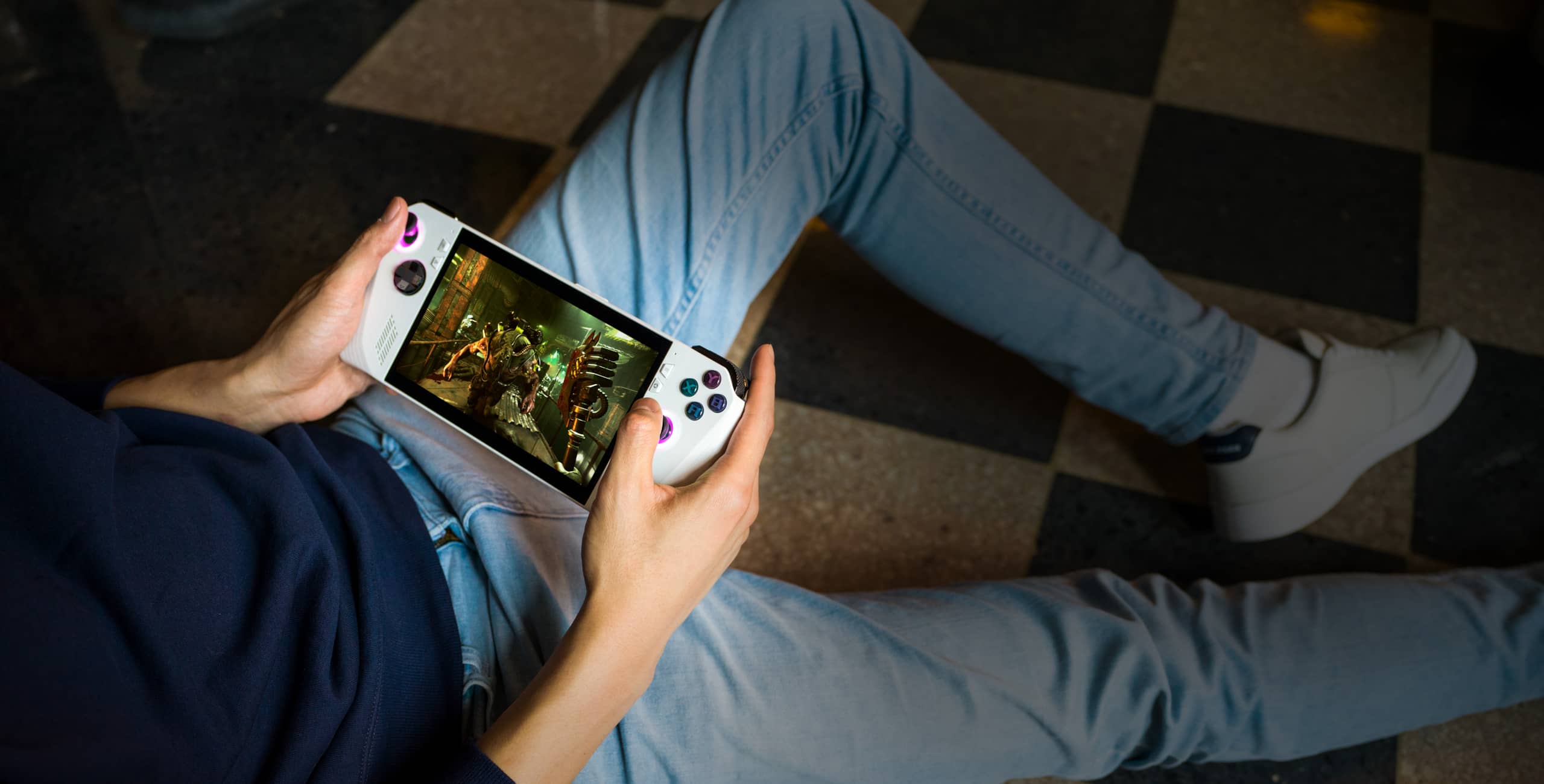 A photo of the ROG G22 on a living room console next to a TV and gamepad.